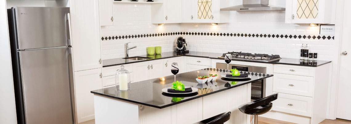 Modern white kitchen with black granite bench top